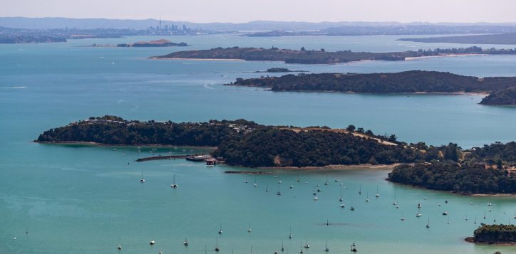 aerial-of-waiheke-island-with-boats-in-the-ocean-with-the-car-ferry-terminal-visible-and-smaller-islands-in-distance-2